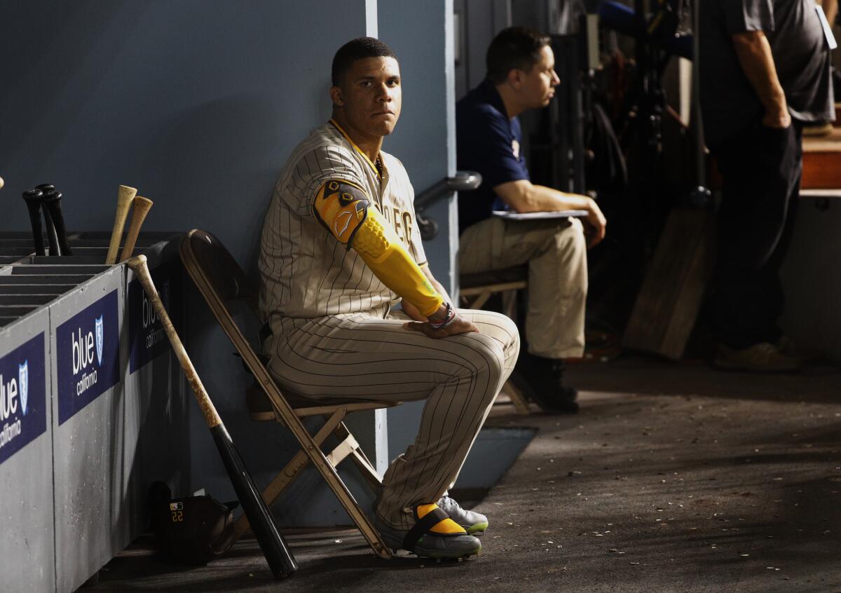 San Diego Padres outfielder Juan Soto sits in the dugout during an 8-1 loss to the Dodgers on Friday night.