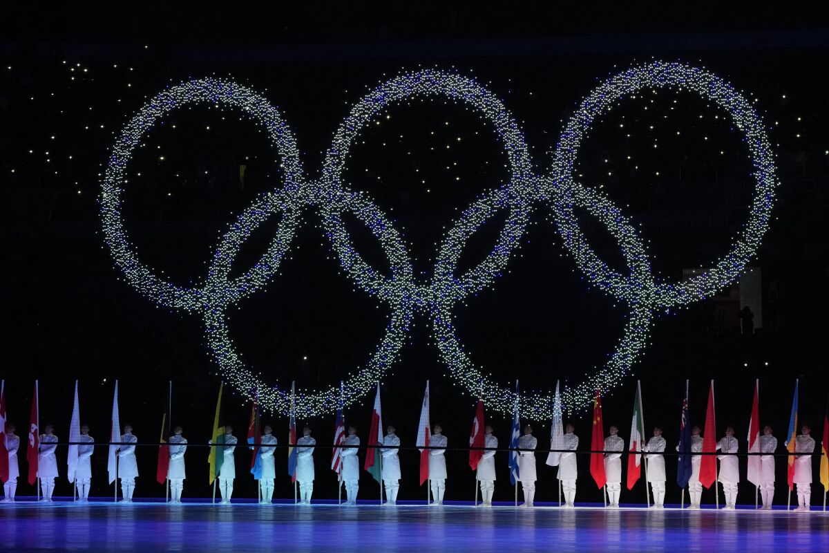 FILE - The Olympic rings during the closing ceremony of the 2022 Winter Olympics, Sunday, Feb. 20, 2022, in Beijing. Officials in the northern Japanese city of Sapporo say there is public support for holding the 2030 Winter Olympics. However, Mayor Katsuhiro Akimoto says the city has no plans to hold a binding public referendum for the final word. (AP Photo/Natacha Pisarenko, File)