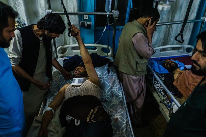 KABUL, AFGHANISTAN -- AUGUST 26, 2021: Family members visit wounded patients who have been admitted into Wazir Akbar Khan Hospital. in Kabul, Afghanistan, Thursday, Aug. 26, 2021. Twin bombings struck near the entrance to KabulOs airport Thursday, ripping through crowds of Afghans and foreign nationals waiting for evacuation from the country. The explosions complicated an already-nightmarish airlift just before the U.S. deadline to remove its troops from the country. (MARCUS YAM / LOS ANGELES TIMES)