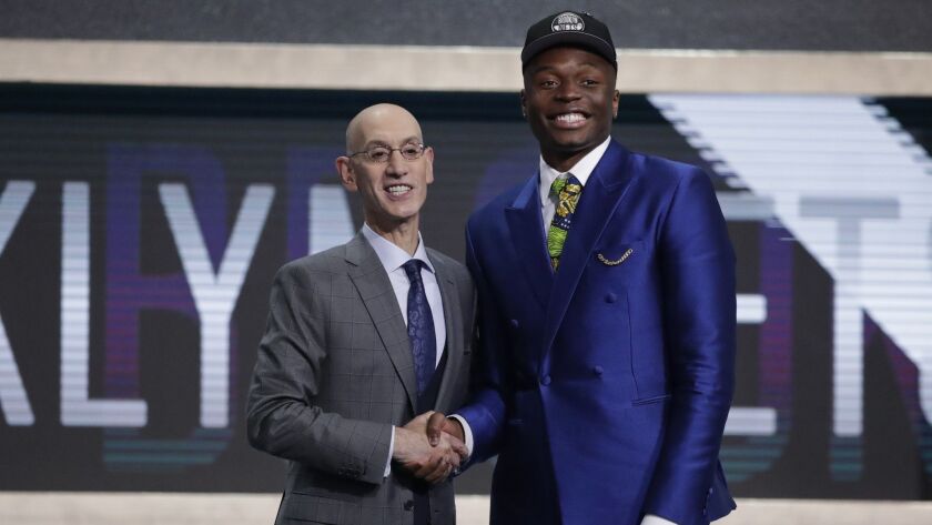 NBA Commissioner Adam Silver shakes Mfiondu Kabengele after the Brooklyn Nets selected him on behalf of the Clippers at 27th overall in the NBA draft.