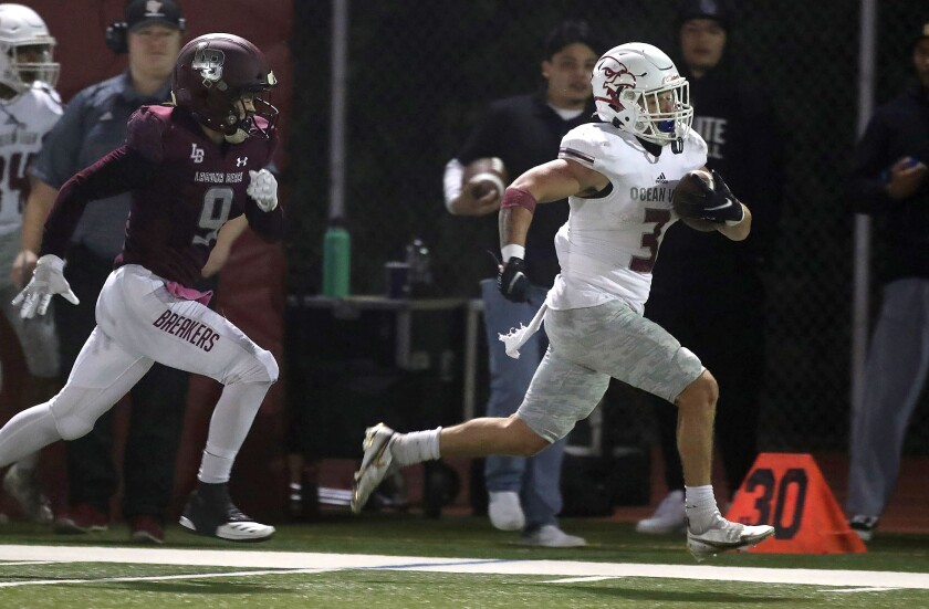 Ocean View's Anthony Ramirez runs down the sideline for a big gain during Friday's game at Laguna Beach.