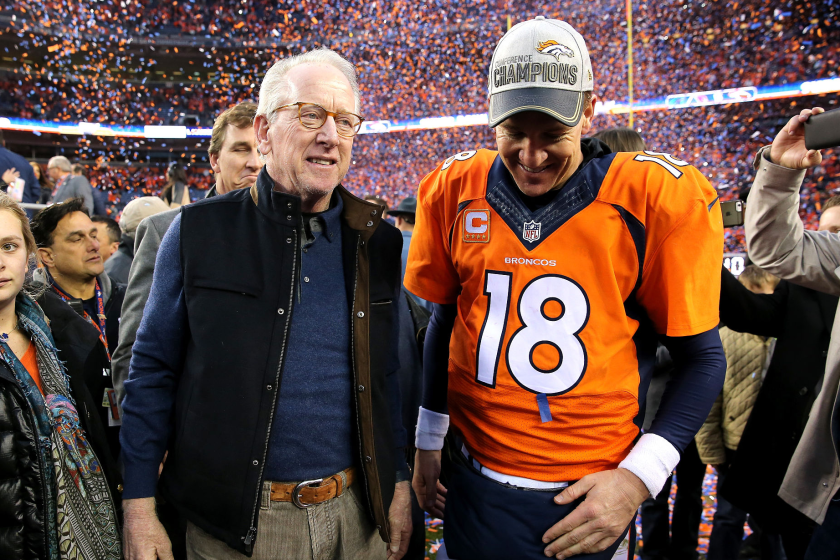 DENVER, CO - JANUARY 24: Peyton Manning #18 of the Denver Broncos and father Archie Manning walk off the field.