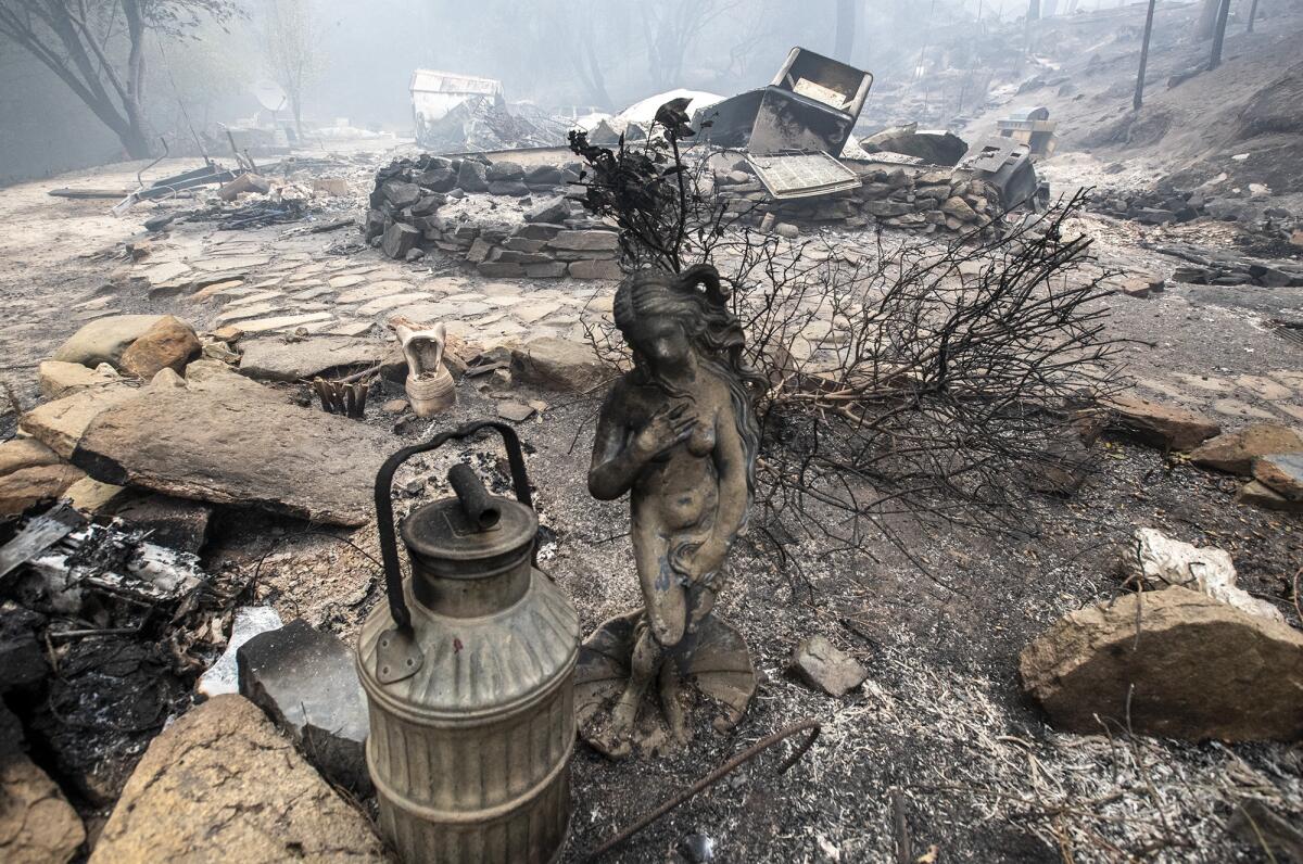 A statue survived flames that destroyed a home in the Bear fire in Feather Falls, Calif.