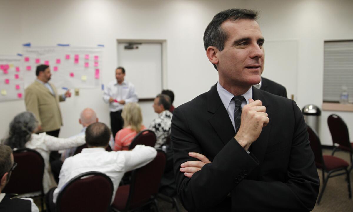 A San Fernando Valley business group delayed taking a position on Mayor Eric Garcetti's yet-to-be unveiled plan to raise minimum wages.