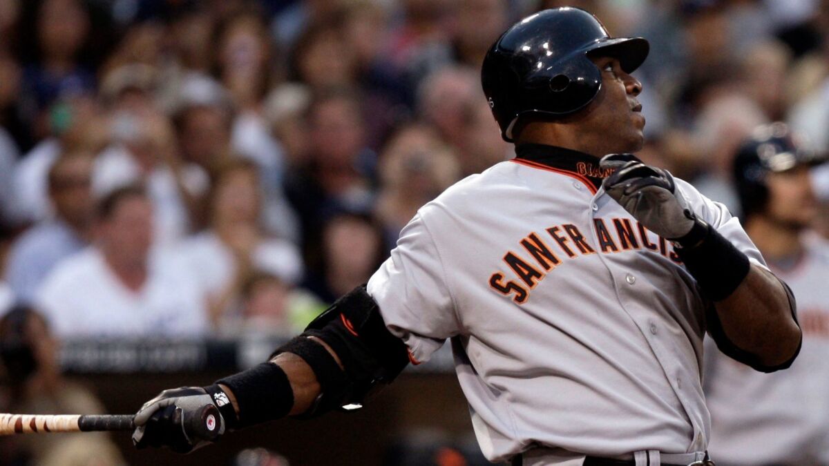 Giants' Barry Bonds watches the flight of his 755th home run during the second inning of game against Padres on Aug. 4, 2007.