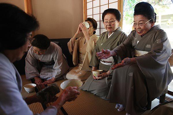 Sosei Matsumoto, right, who was the first to teach the tea ceremony in the new Pasadena teahouse, receives a ceremonial bowl of tea at a farewell.