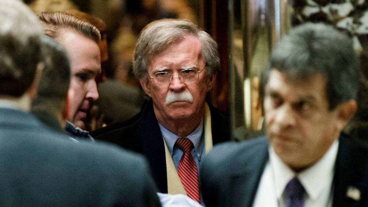 John Bolton (C) arrives for a meeting with then-President-elect Donald Trump at Trump Tower in New York in December of 2016.
