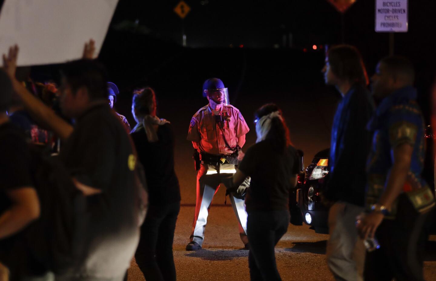 A police officer blocks the onramp to a freeway during the police-shooting protest in El Cajon.