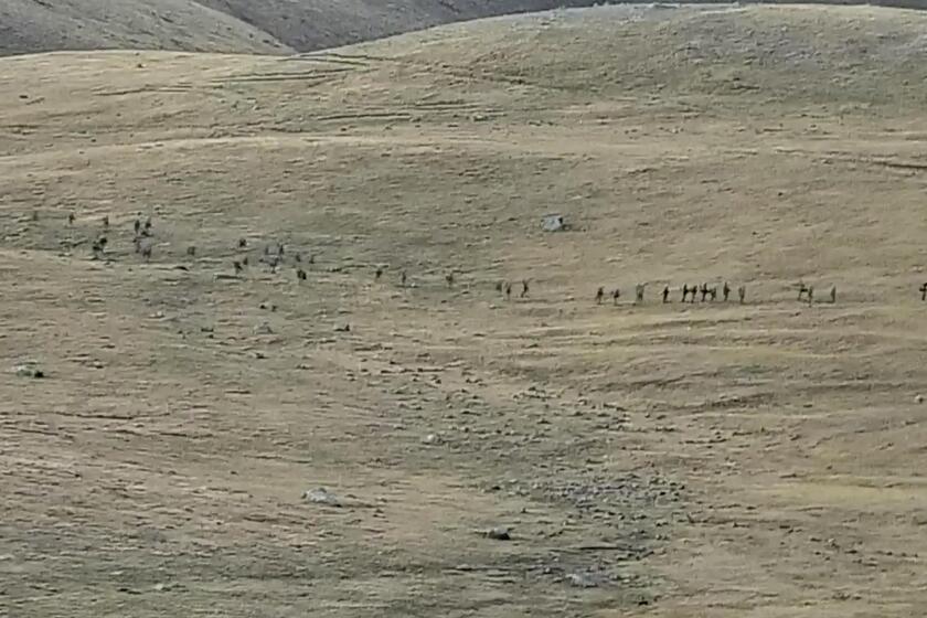 This image taken from a YouTube footage released by Armenian Defense Ministry on Tuesday, Sept. 13, 2022, shows Azerbaijanian servicemen crossing the Armenian-Azerbaijani border and approaching the Armenian positions. Armenia's prime minister says that 49 soldiers have been killed in nighttime attacks by Azerbaijan. (Armenian Defense Ministry via AP)