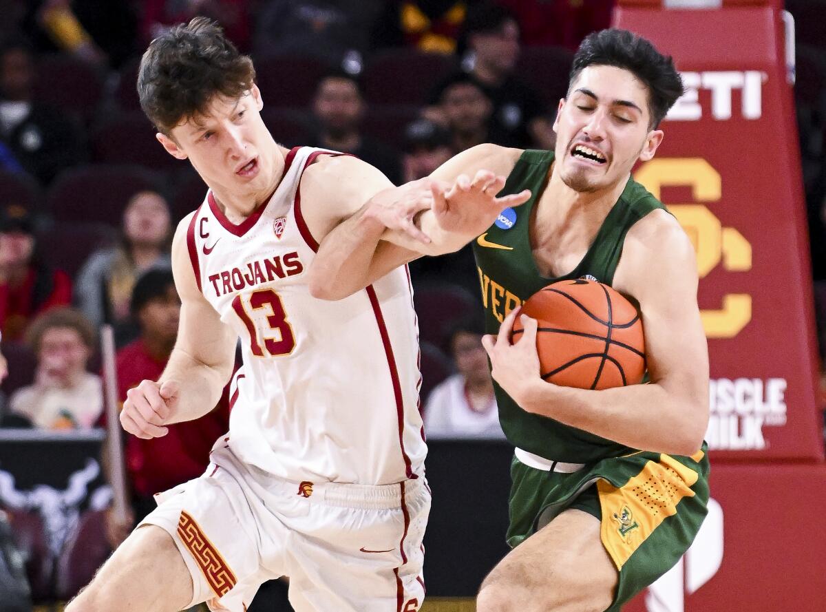 USC guard Drew Peterson attempts to steal the ball from Vermont guard Robin Duncan.