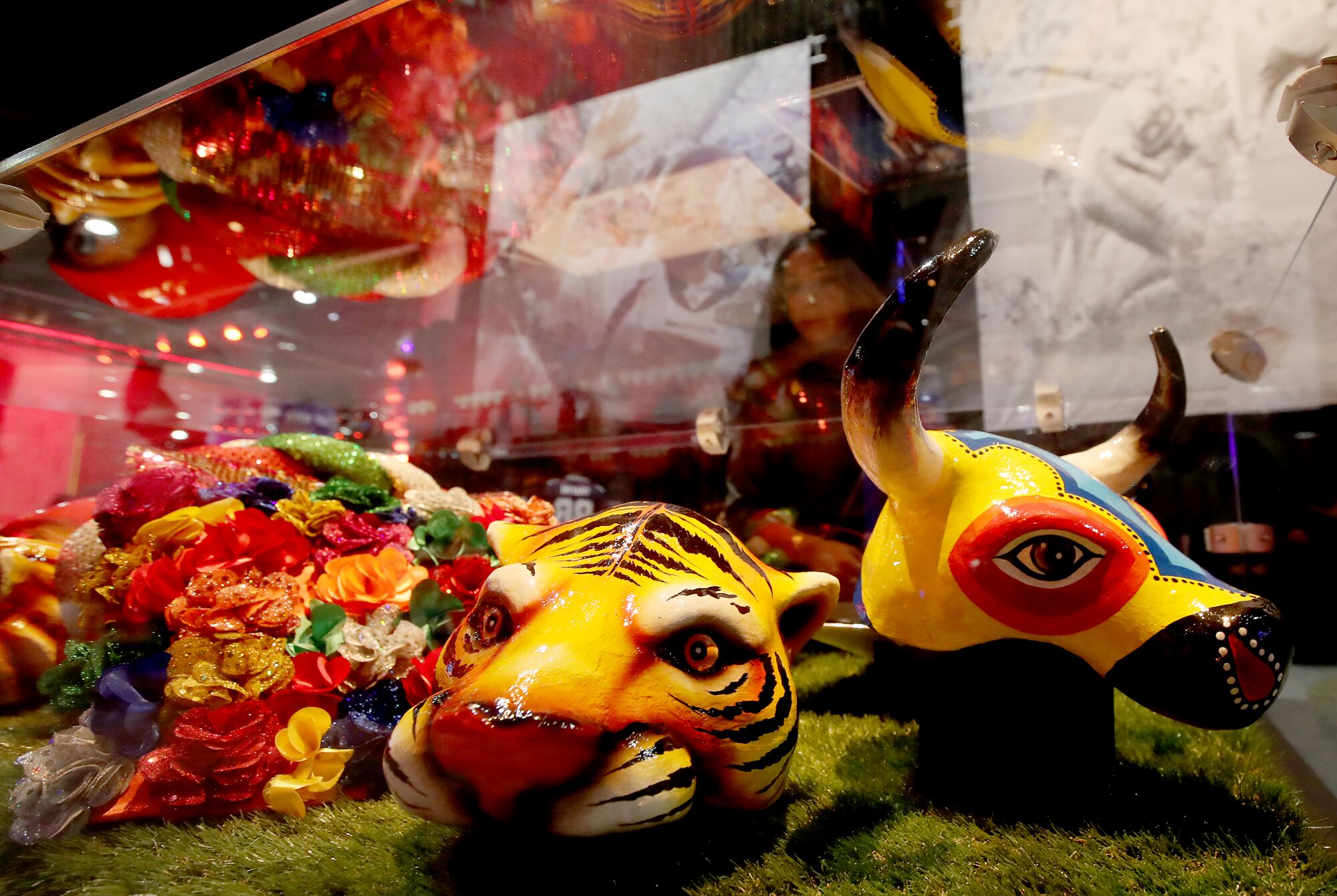 A fan looks at costume pieces worn by pop stars Shakira and Jennifer Lopez during the Super Bowl LIV halftime show.
