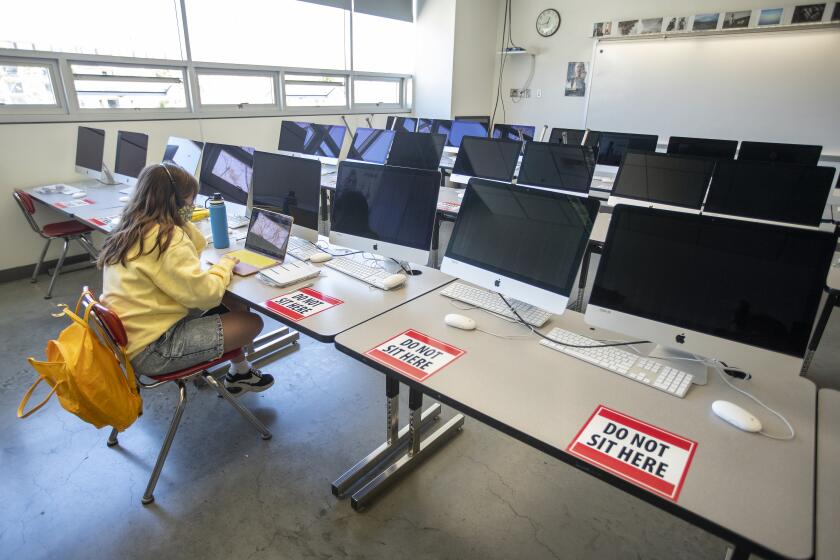 LOS ANGELES, CA - APRIL 29, 2021: Alaina Ortiz, 17, a senior at Ramon C. Cortines Visual and Performing Arts High School in downtown Los Angeles attends her video editing class on campus for the first time in more than a year, due to the coronavirus outbreak. Students at the school currently have the option of attending class on campus or online. (Mel Melcon / Los Angeles Times)