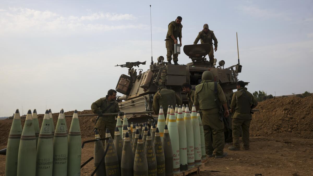 Israel calls for siege of Gaza as it masses troops at border - Los Angeles  Times
