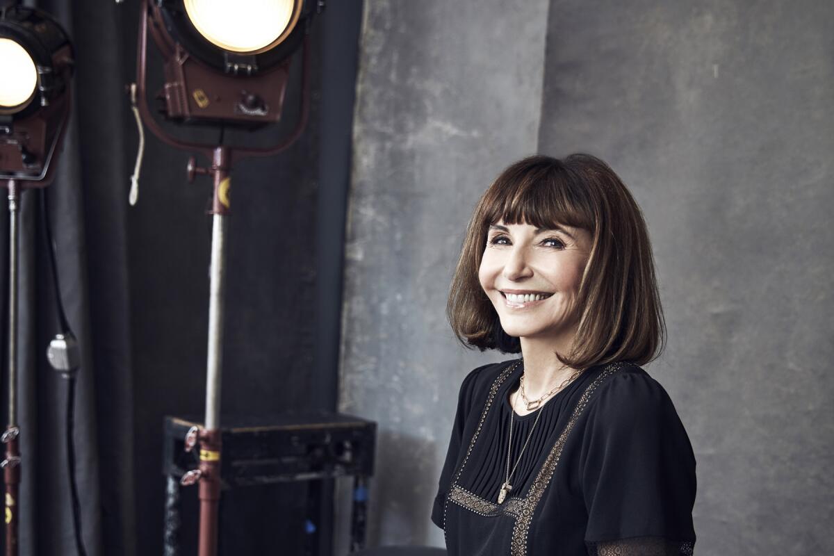 Mary Steenburgen sits and smiles under studio lights