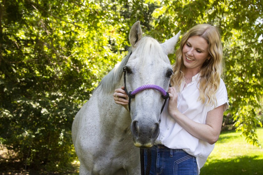 Savanah Stuart with Atlas, a horse at Little Hooves Rescue Farm in Rancho Santa Fe.