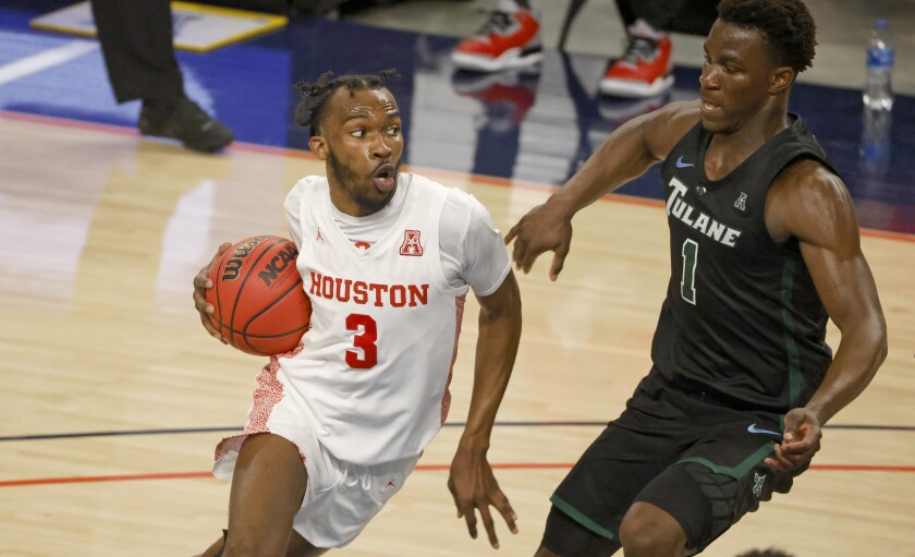 Houston guard DeJon Jarreau (3) drives past Tulane guard Sion James (1) during the second half of an NCAA college basketball game in the quarterfinals of the American Athletic Conference men's tournament Friday, March 12, 2021, in Fort Worth, Texas. (AP Photo/Ron Jenkins)