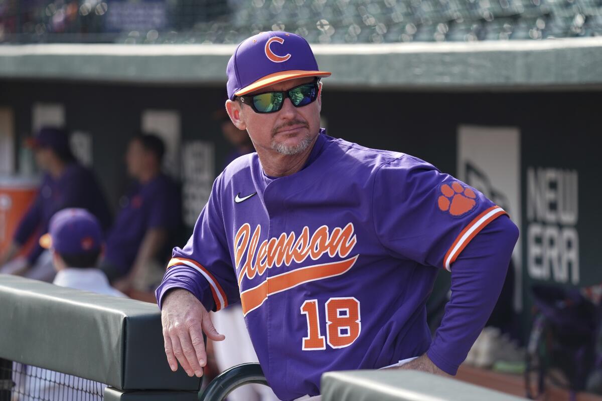 Will Clark looks out from a dugout before a baseball game between