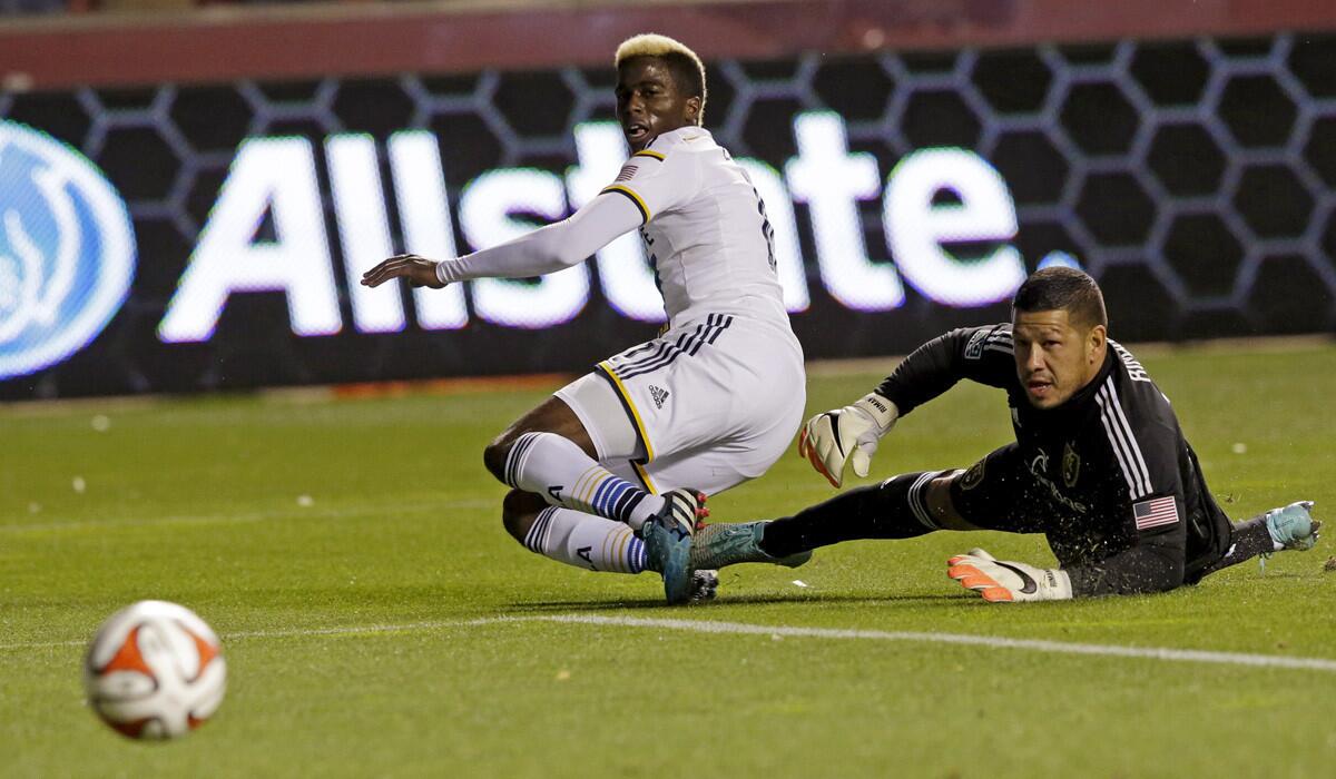 Galaxy forward Gyasi Zardes and Real Salt Lake goalkeeper Nick Rimando watch a shot by Zardes go wide of the goal in the first half Saturday.