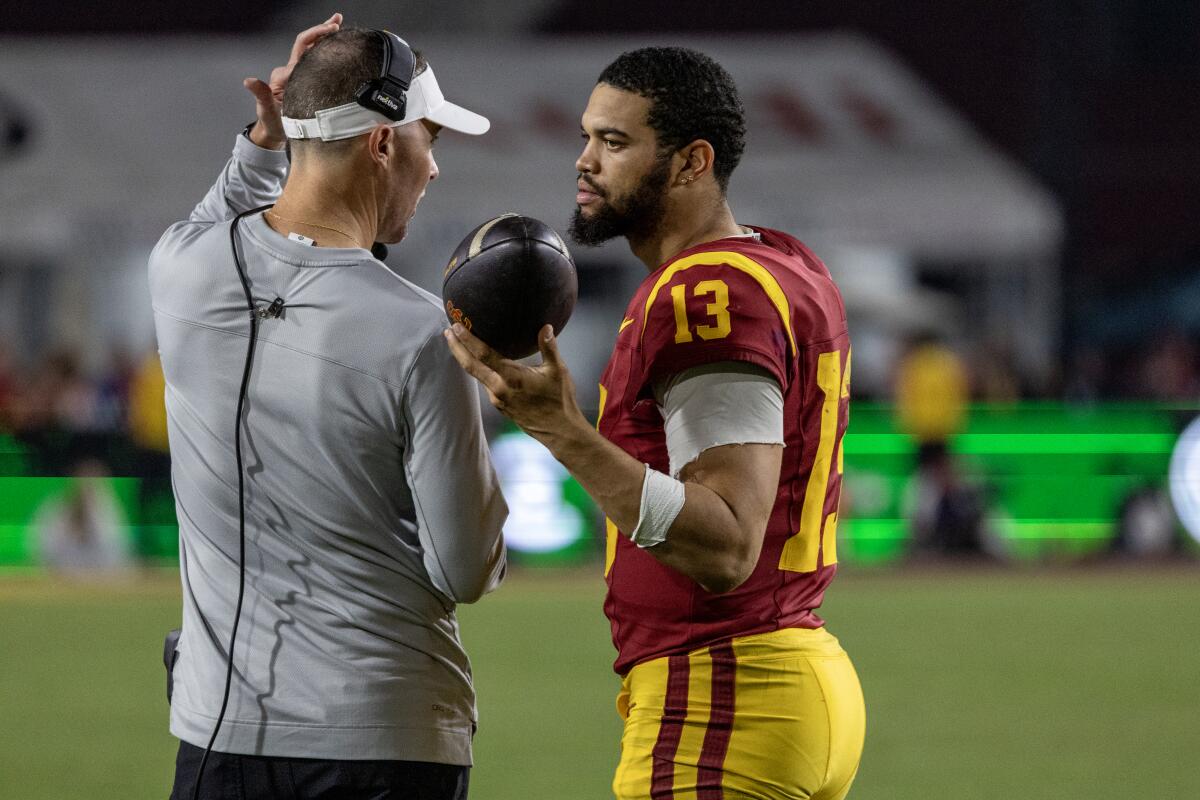 USC coach Lincoln Riley, left, speaks with quarterback Caleb Williams.