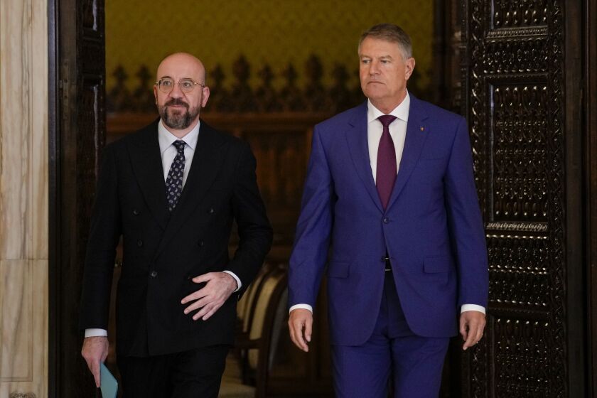 European Council President Charles Michel, left, arrives with Romanian President Klaus Iohannis for joint statements at the Cotroceni Presidential Palace in Bucharest, Romania, Monday, March 27, 2023. (AP Photo/Andreea Alexandru)