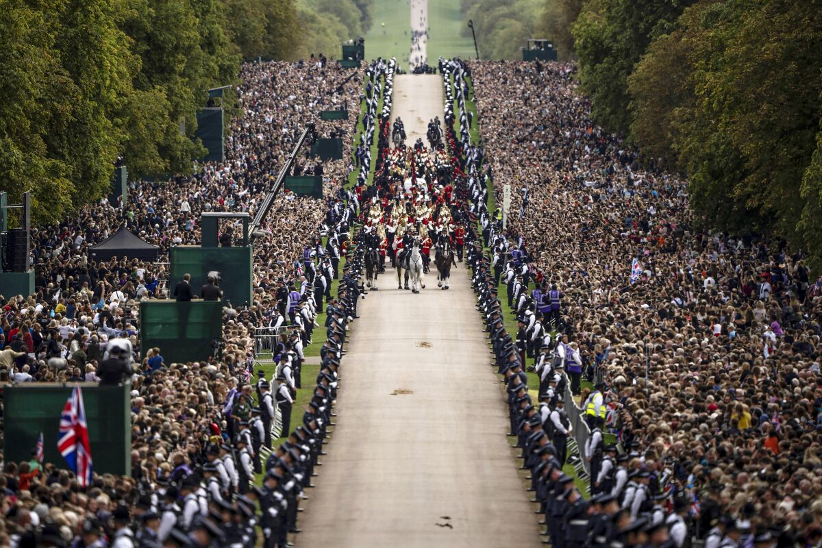 People line the road as Queen Elizabeth II's coffin is escorted to Windsor Castle