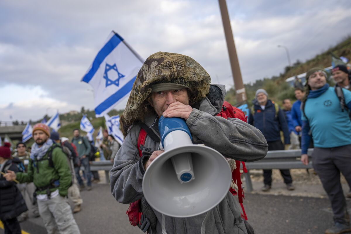Protesting Israeli military reservist with a bullhorn