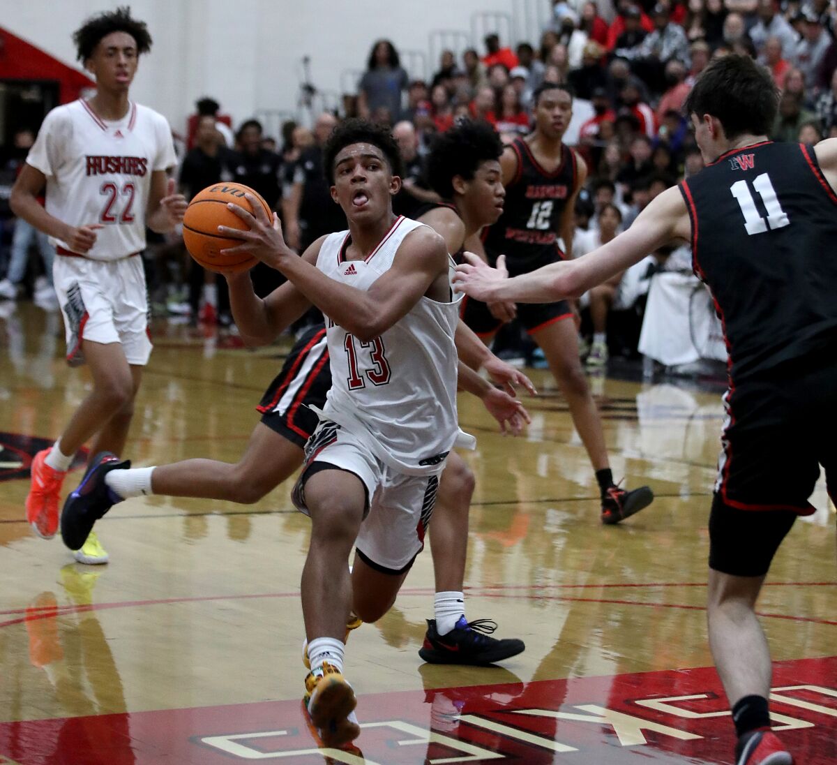 Corona Centennial guard Eric Freeney prepares to attempt a layup against Harvard-Westlake.