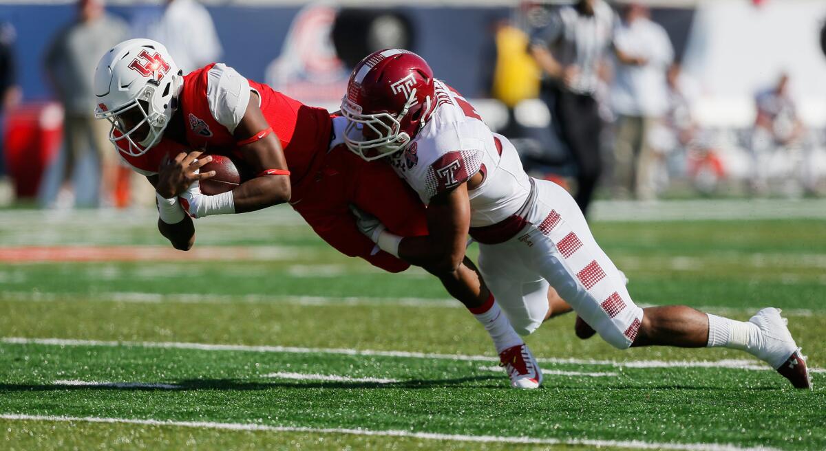 Houston quarterback Greg Ward Jr. of the Houston Cougars is tackled by Temple defensive back Will Hayes on Dec 5.