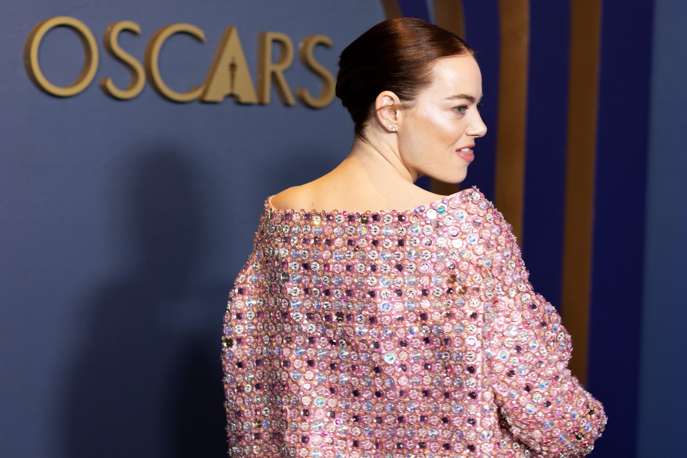 Emma Stone at the recent Governors Awards wears a sparkly pink outfit.