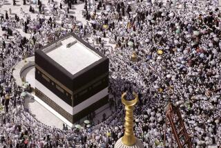 Thousands of Muslim pilgrims hold umbrellas as they circumambulate around the Kaaba, the cubic building at the Grand Mosque, during the annual Hajj pilgrimage, in Mecca, Saudi Arabia, Sunday, June 25, 2023. Muslim pilgrims are converging on Saudi Arabia's holy city of Mecca for the largest Hajj since the coronavirus pandemic severely curtailed access to one of Islam's five pillars. (AP Photo/Amr Nabil)