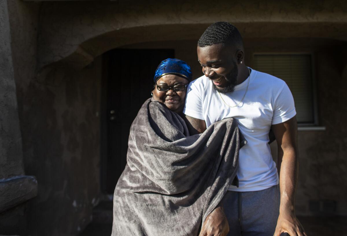 Linda Reedy hugs her grandson Damion Lester Jr., who is the valedictorian at Washington Prep High School in Los Angeles. She has helped raise him since he was 3.