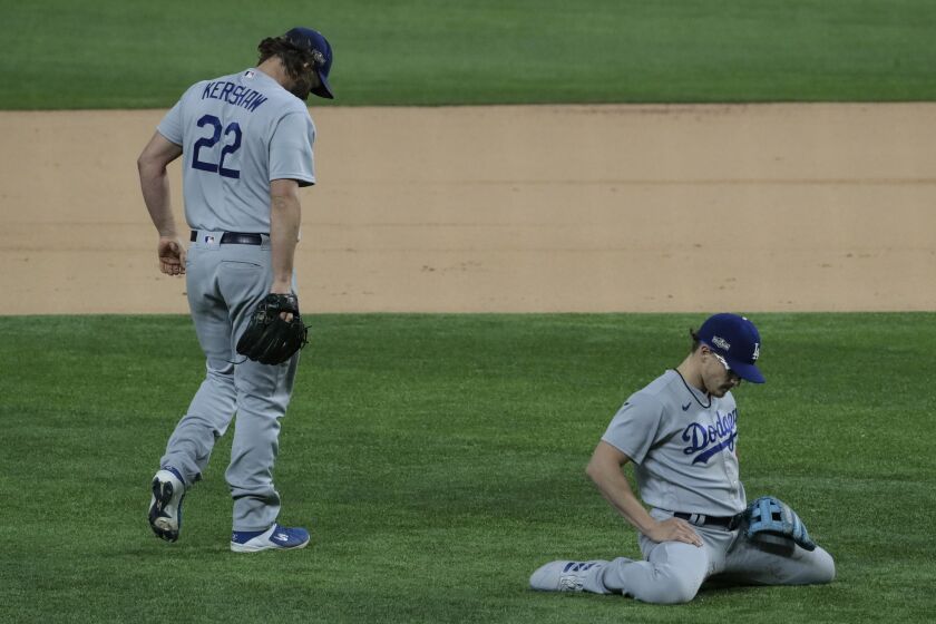 Dodgers pitcher Clayton Kershawand shortstop Enrique Hernandez fail to prevent an infield single against Atlanta on Thursday.