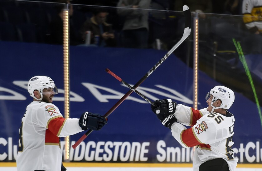 Florida Panthers defenseman Keith Yandle, left, and center Noel Acciari (55) celebrate after the team's win against the Nashville Predators in an NHL hockey game Saturday, March 6, 2021, in Nashville, Tenn. Acciari scored three goals against the Predators giving him a hat trick. (AP Photo/Mark Zaleski)