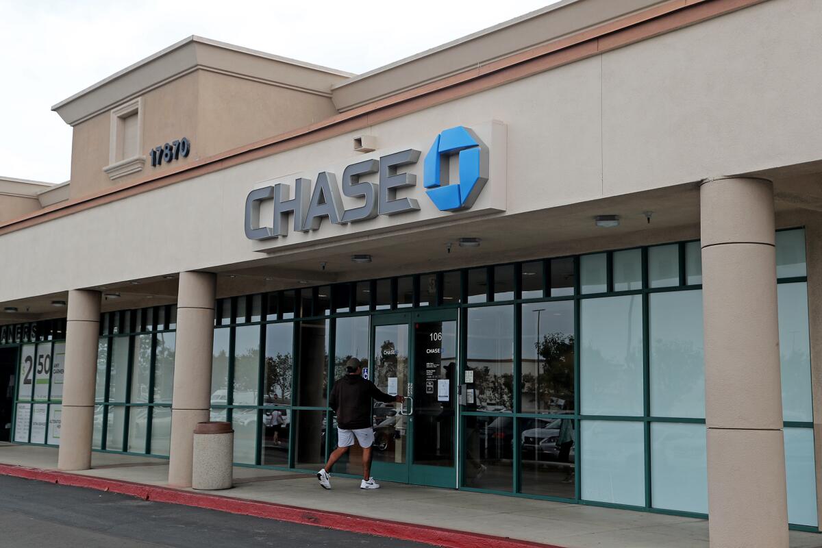 A man enters the Chase Bank in Fountain Valley.