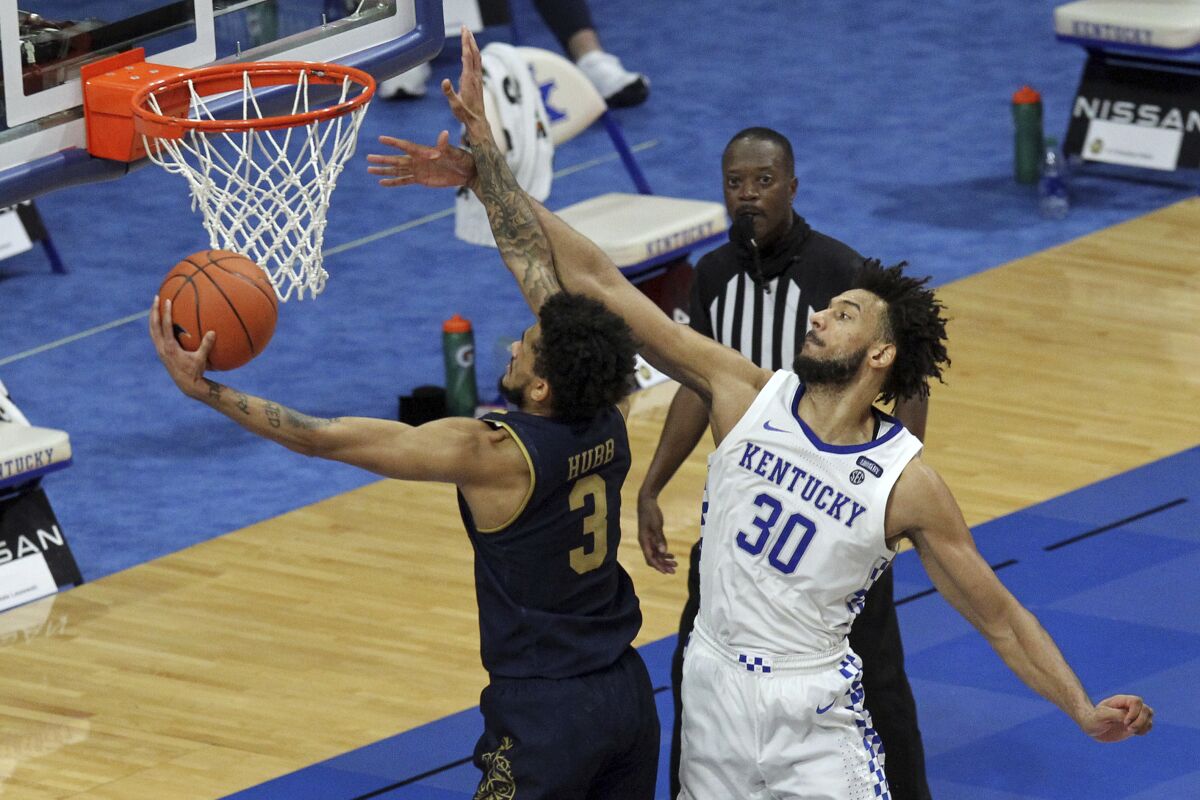 Notre Dame's Prentiss Hubb (3) shoots while defended by Kentucky's Olivier Sarr (30) during the second half of an NCAA college basketball game in Lexington, Ky., Saturday, Dec. 12, 2020. Notre Dame won 64-63. (AP Photo/James Crisp)
