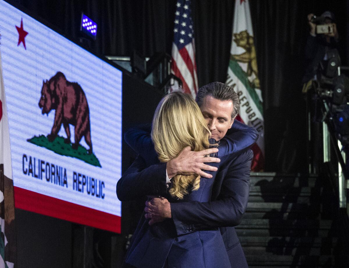 Joined by his wife Jennifer Siebel Newsom, Gavin Newsom takes the stage as the new California Governor at Exchange LA on election night in downtown Los Angeles.