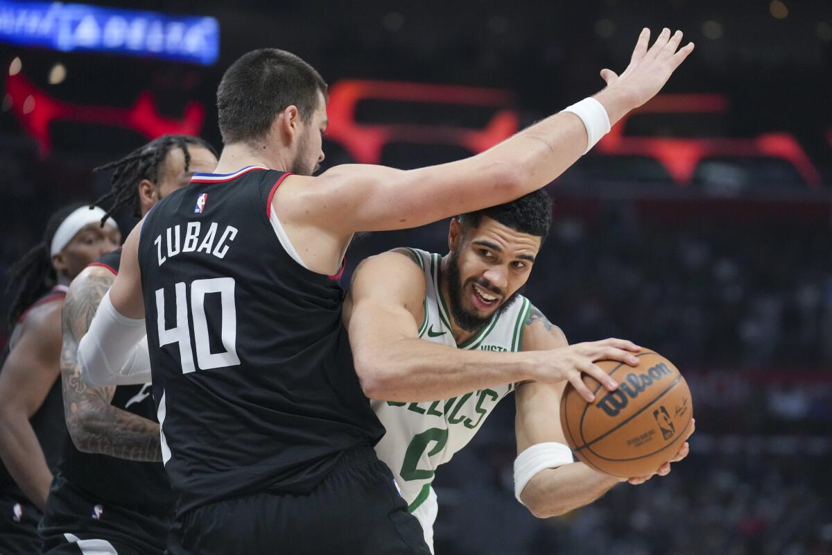 Clippers center Ivica Zubac tries to prevent Celtics forward Jayson Tatum from scoring in the lane. 