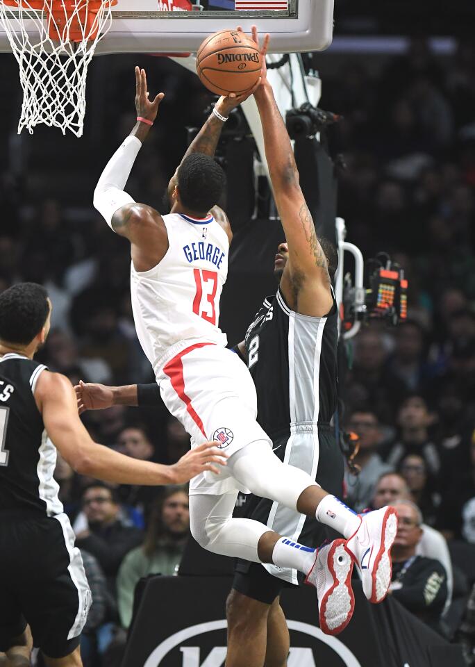 Spurs forward LaMarcus Aldridge, right, blocks a shot by Clippers forward Paul George during the second quarter.