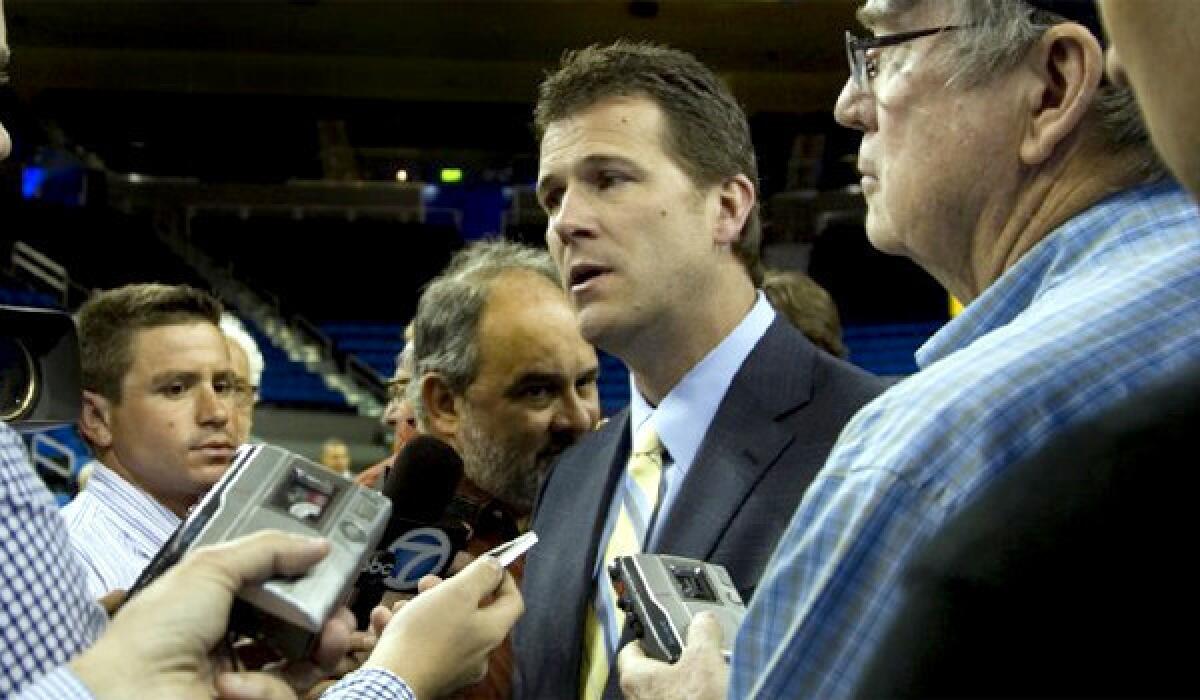 New Mexico seeks $1 million for a contract buyout now that Steve Alford, center, has joined UCLA.