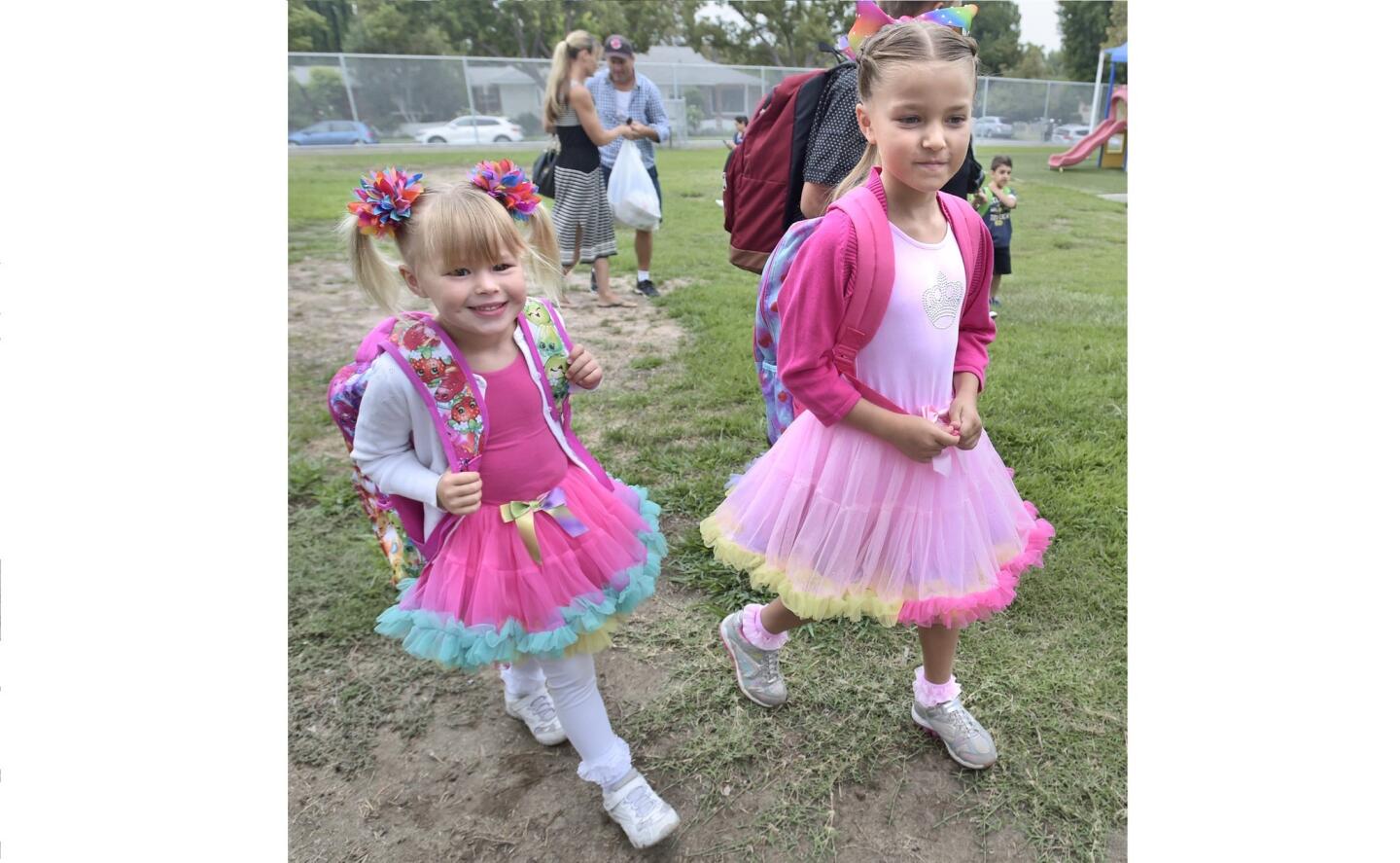 Olivia, left, and Chloe Rogerson, who are sisters, head for their classrooms at Thomas Jefferson Elementary School. (photo by Dan Watson)