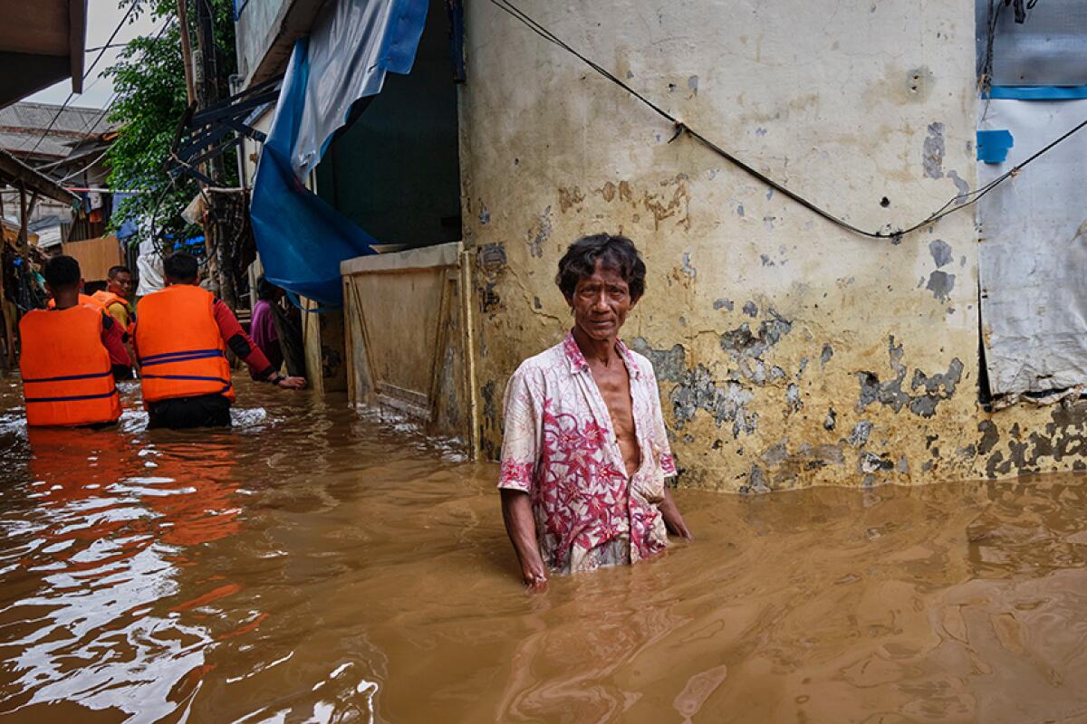 A man wades through floodwaters near his home in Jakarta, Indonesia, on Friday.