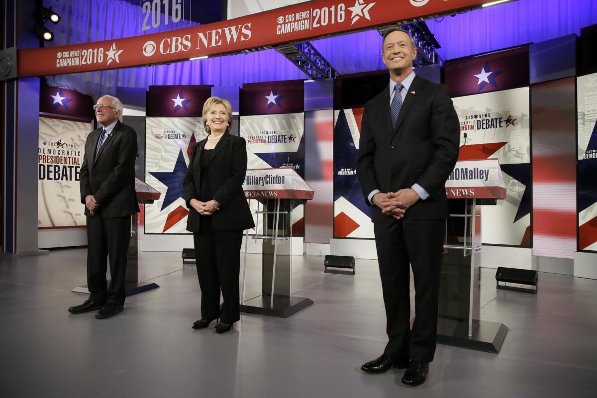 Democratic presidential candidates Bernie Sanders, left, Hillary Rodham Clinton and Martin O'Malley take the stage before a Democratic presidential primary debate, Saturday, Nov. 14, 2015, in Des Moines, Iowa. (AP Photo/Charlie Neibergall)