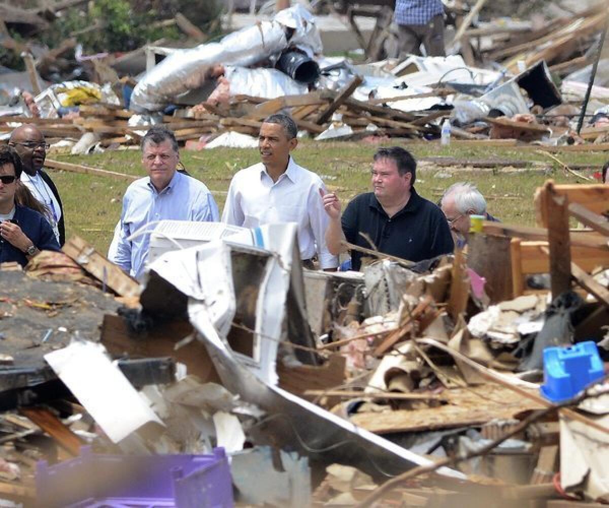 President Obama tours the devastation Sunday in Moore, Okla., left by last week's tornado that ripped through the Oklahoma City area, killing 24.