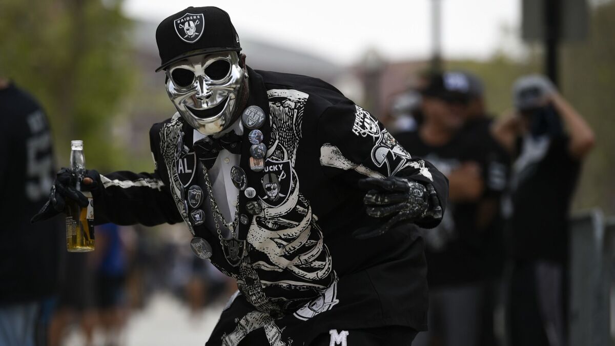 A Oakland Raider fan poses before a preseason game against the Rams.