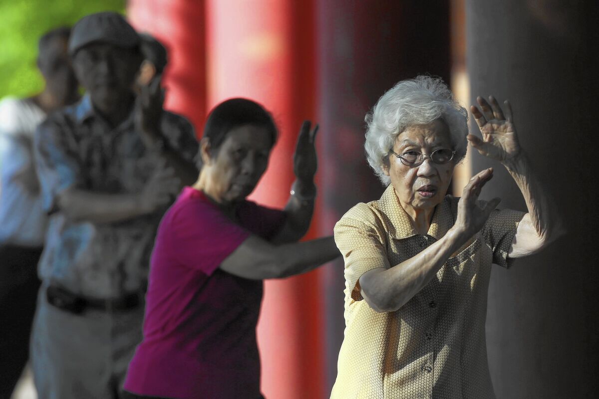 A group practices tai chi at Alpine Recreation Center in Los Angeles' Chinatown.