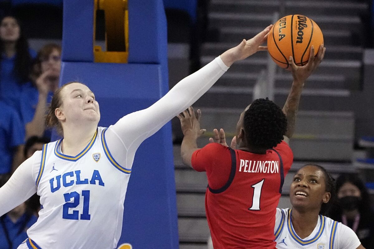 UCLA forward Lina Sontag (left) attempts to block a shot by Arizona defenseman Shayna Pellington during the Wildcats' Feb. 20 win.  3.