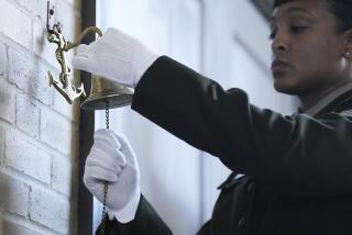 Sgt. Gabriela Corbalan rings a bell as the names of the soldiers from the 3rd Battalion, 24th Infantry Regiment, are read during an event at the Buffalo Soldiers Museum, Monday, Nov. 13, 2023, in Houston. U.S. Army officials say they will overturn the convictions of over 100 Black soldiers accused of a mutiny at a Houston military camp a century ago in a trial that had racial undertones. (Elizabeth Conley/Houston Chronicle via AP)
