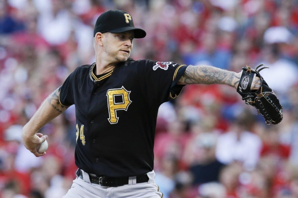 Pirates starting pitcher A.J. Burnett throws in the second inning against the Reds on July 30.