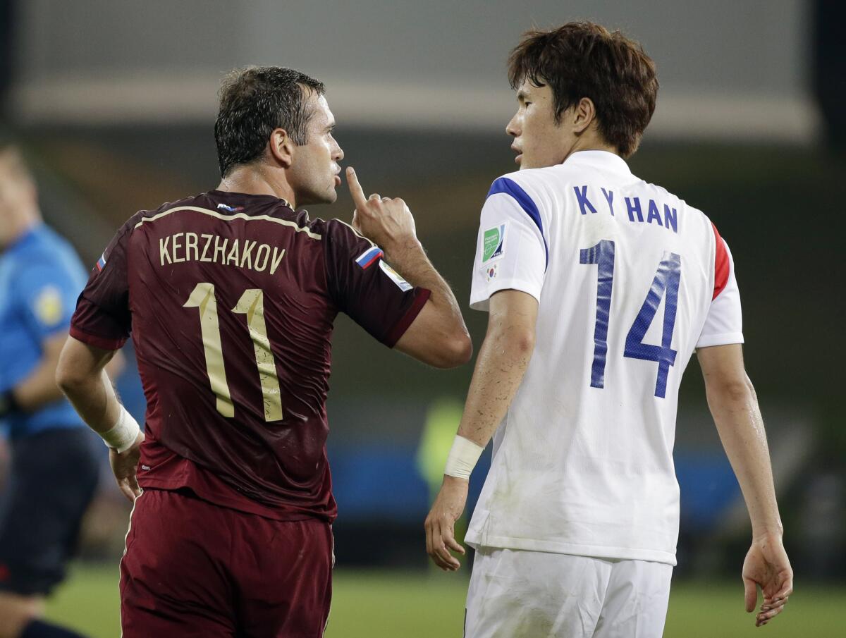 Russia's Alexander Kerzhakov, left, gives a quiet sign to South Korea's Han Kook-young during their World Cup game on Tuesday.