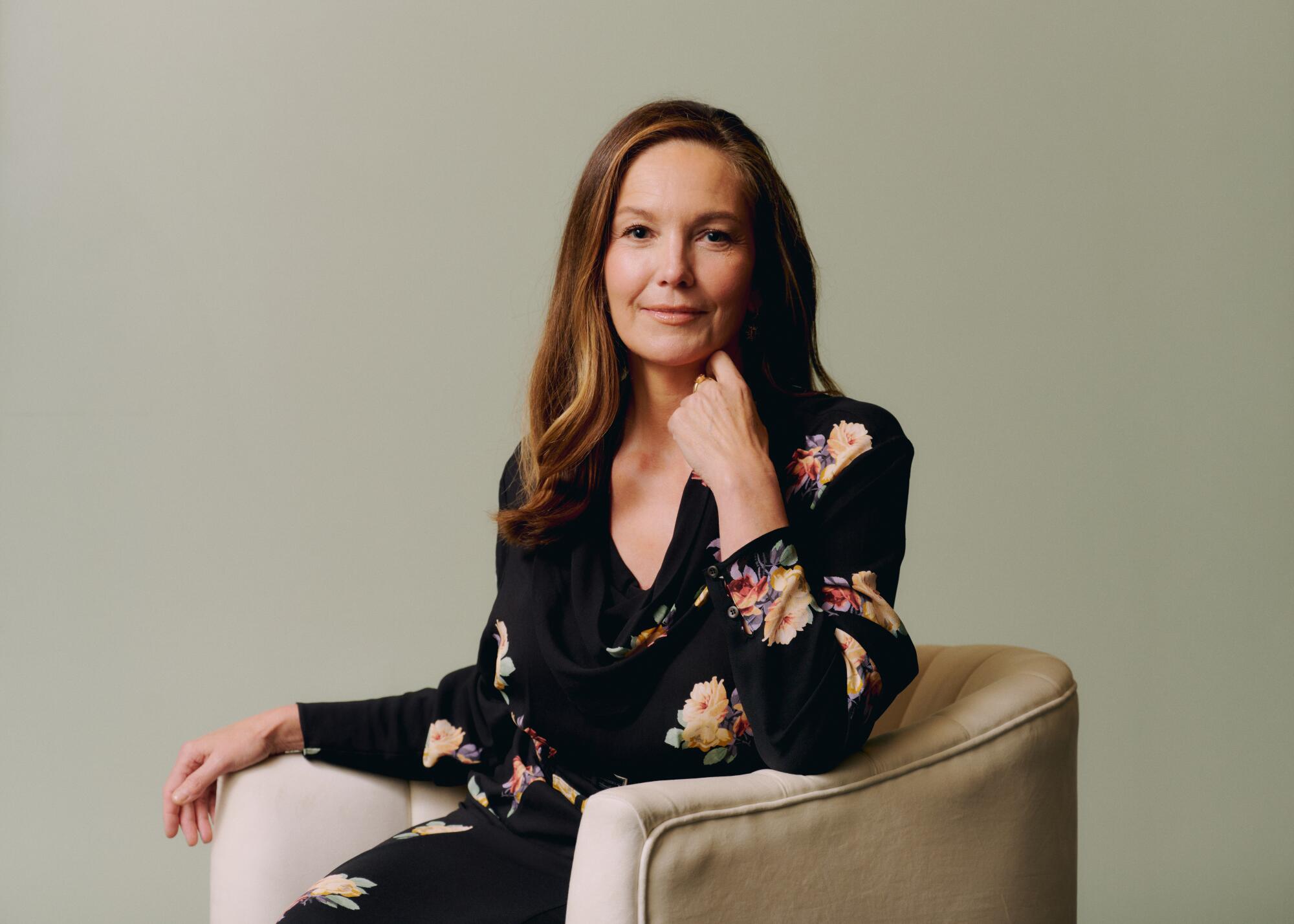 Diane Lane poses for a portrait in a V-neck flower-print dress.